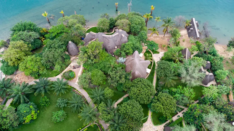 Vue aérienne des villas sous chaume dans les jardins tropicaux, le long de la rive du lac Tanganyika